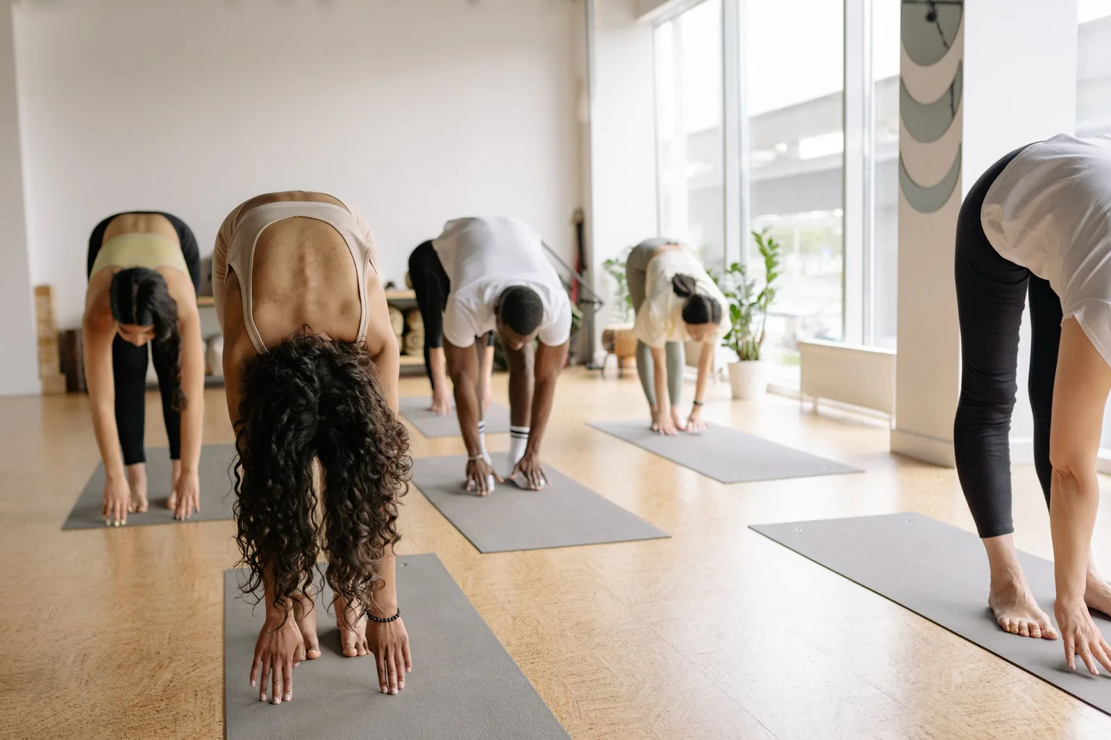 A forward bend sequence in the bright studio